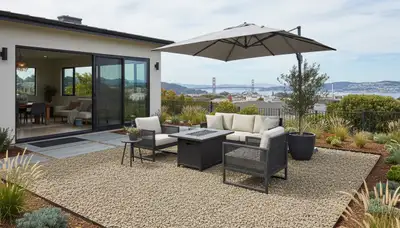 Professional pea gravel patio installation with edging and furniture in San Francisco, CA landscaping